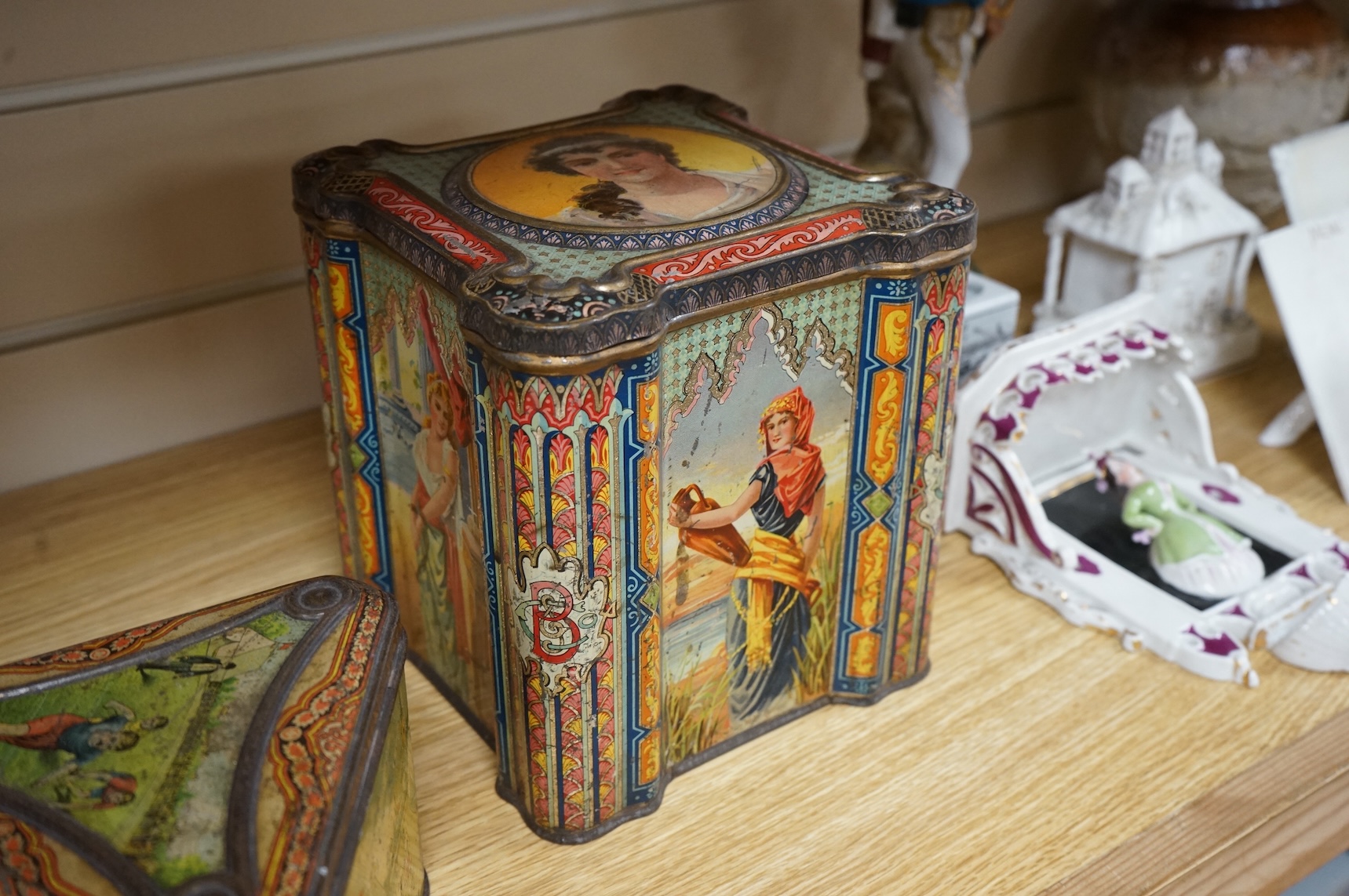 A Windmill biscuit tin by Huntley & Palmer: Reading & London, 'BIVM' Eastern Beauties tea tin and Huntley & Palmers triangular biscuit tin with 'Sports' motifs
